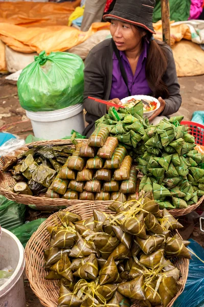 Khmer woman selling traditional asian food rice in banana leaves. Siem Reap, Cambodia