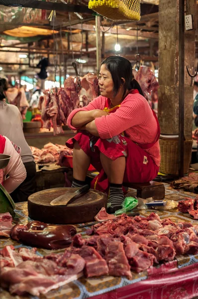 Khmer woman selling meat at traditional food marketplace. Cambodia