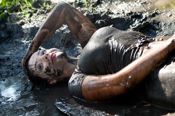 Woman lying in the mud