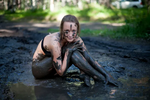 Woman lying in the mud