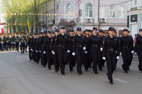 Squad of female police officers in a celebratory column