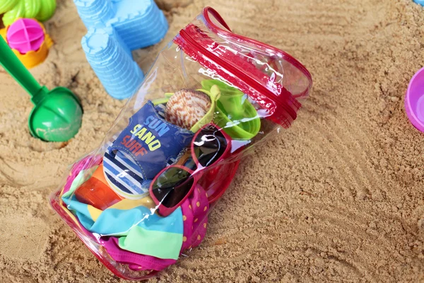 Bag of little traveler on sand