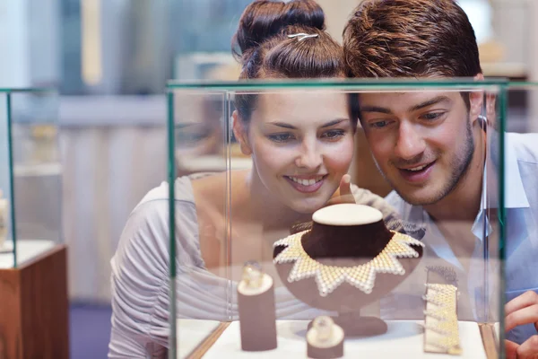 Happy young couple in jewelry store