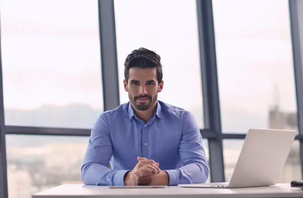 Happy young business man at office