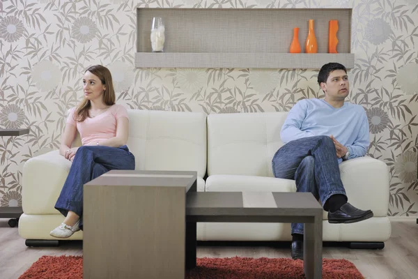 Couple relax at home on sofa in living room