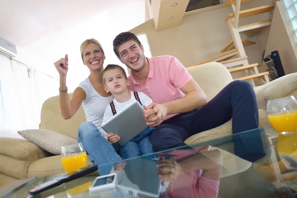 Family at home using tablet computer