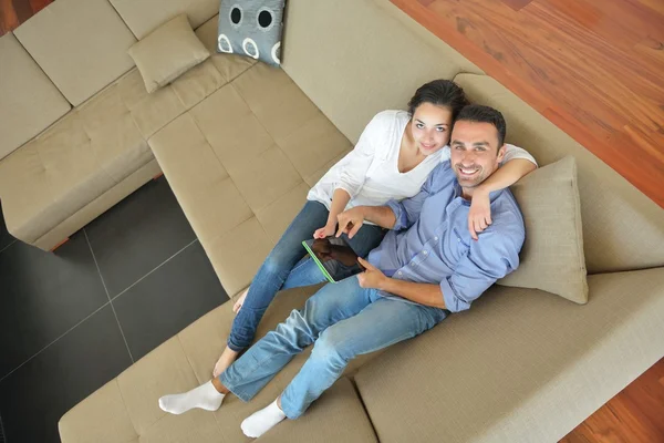 Couple at home using tablet computer
