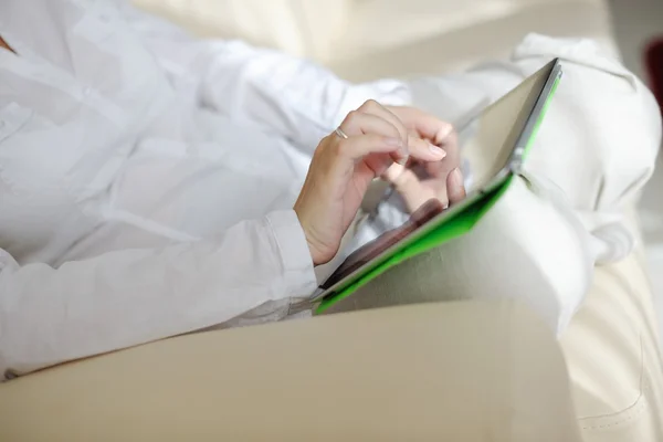 Woman using tablet pc at home