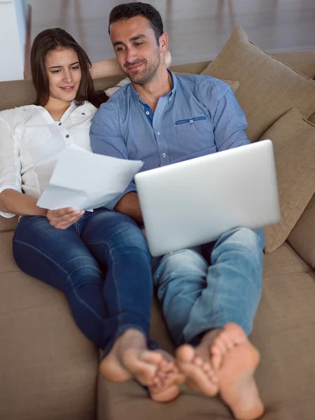 Relaxed young couple working on laptop computer at home