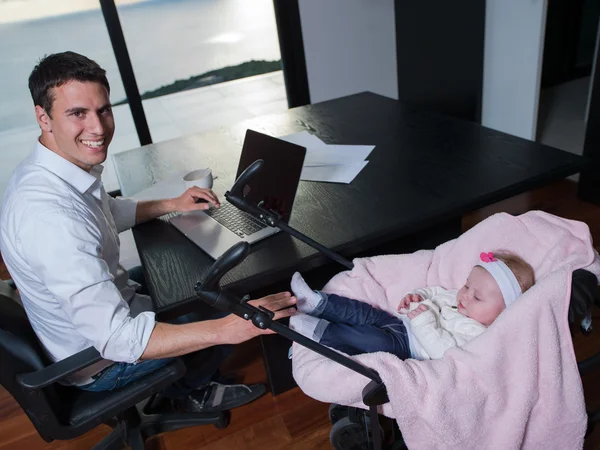 Man working from home and take care of baby