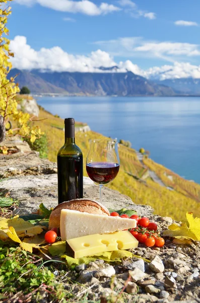 Red wine, cheese, bread and cherry tomatoes