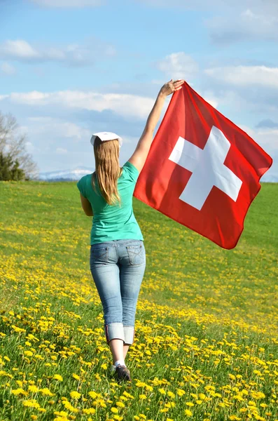 Girl holding Swiss flag.