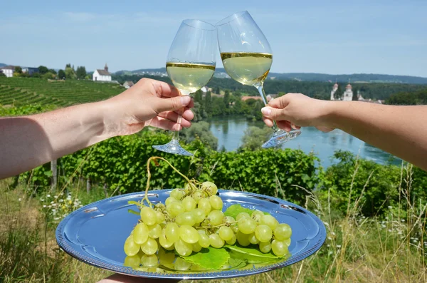 Wineglasses against vineyards
