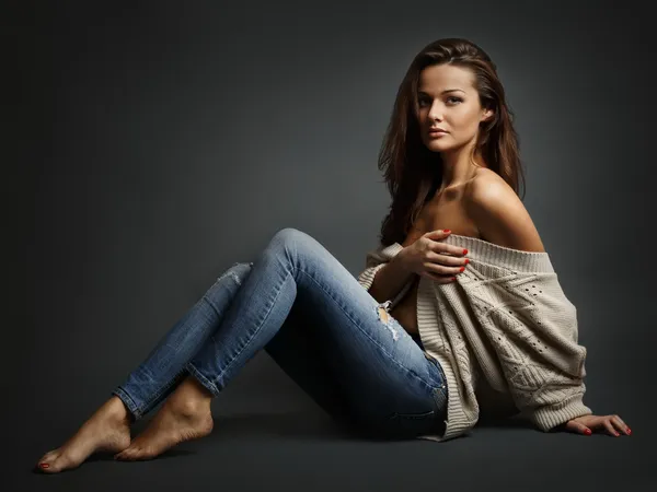 Young beautiful woman sitting on floor