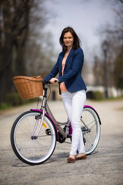 Urban biking - middle-age woman and bike in city