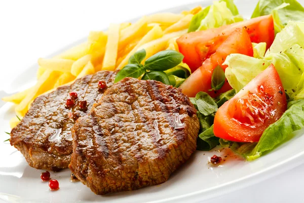 Grilled steak, French fries and vegetables