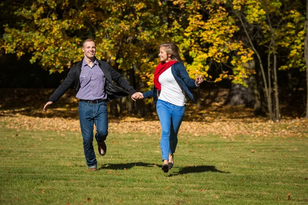 Woman and man running in park