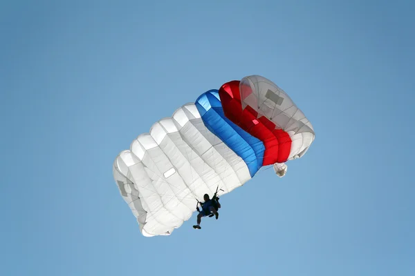 Parachutist on blue sky extreme sport
