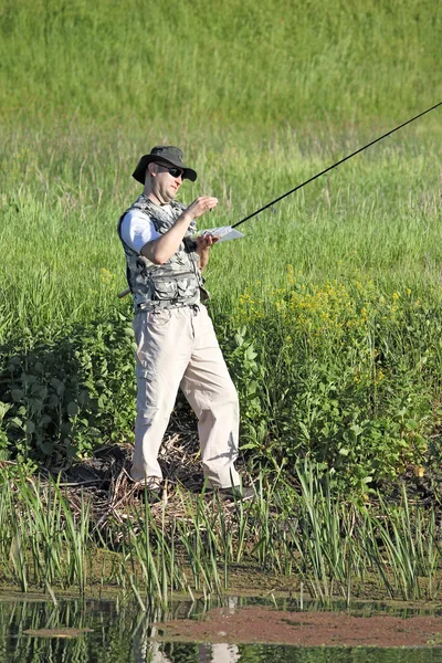 Fisherman prepares for fishing on river