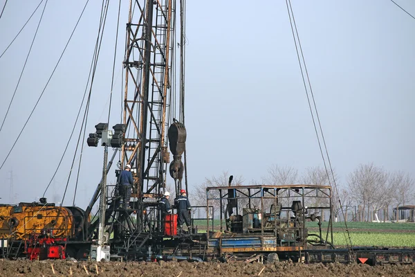 Oil workers on land drilling rig
