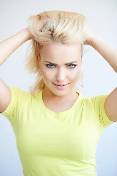 Beautiful blond woman frowning at the camera