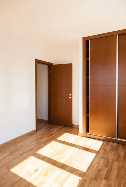 Empty room with door and wardrobe