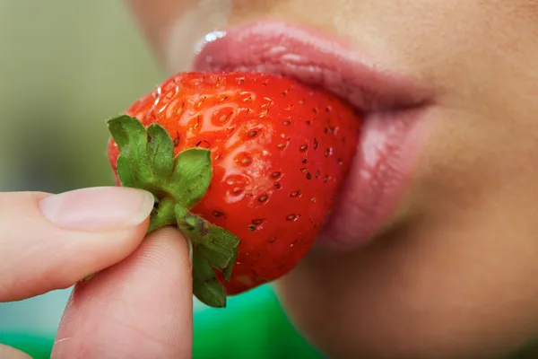 Lips and strawberry.