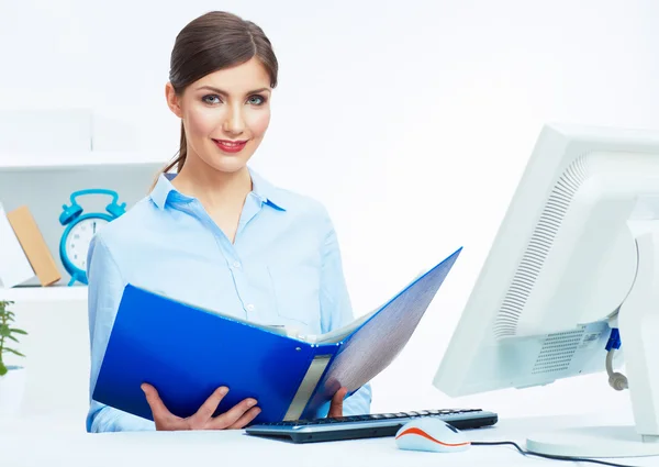 Business woman working with paper at computer in white office