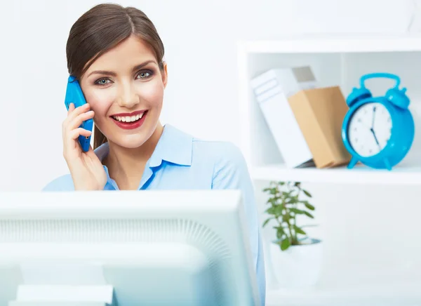 Business woman on phone in white office.
