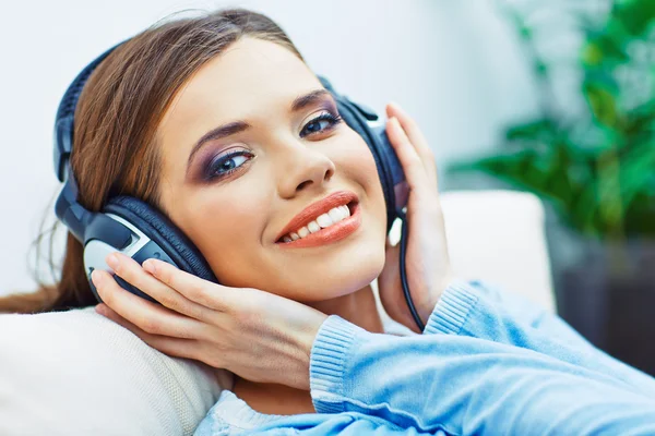 Happy smiling woman listening music with headphones.