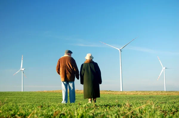 Seniors\' couple and wind turbines