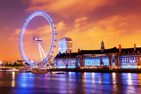 London, England the UK skyline in the evening, London Eye illuminated