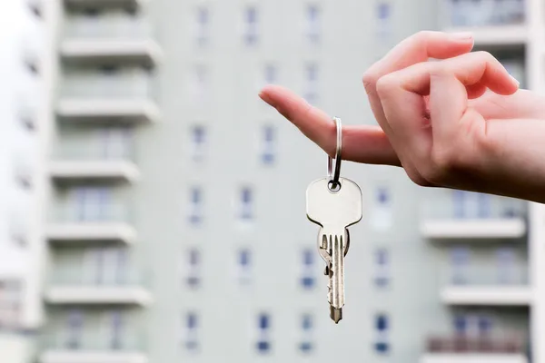 Real estate agent holding keys to a new apartment