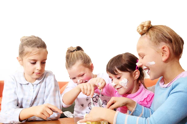 Group Of Children Eating cake together and smiling