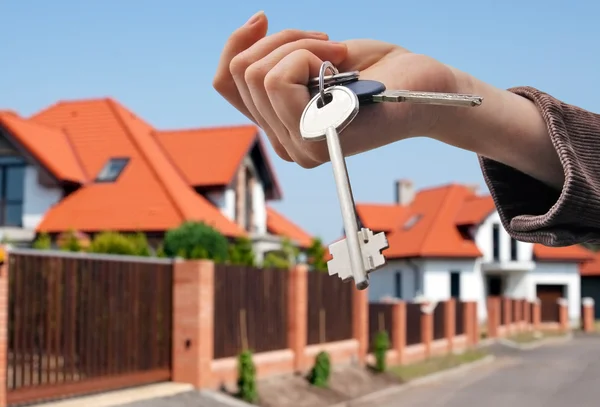 Handing keys in the house background