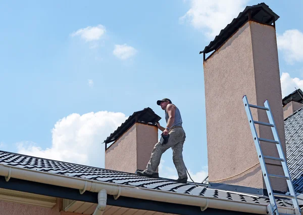 Construction workers repairing roof