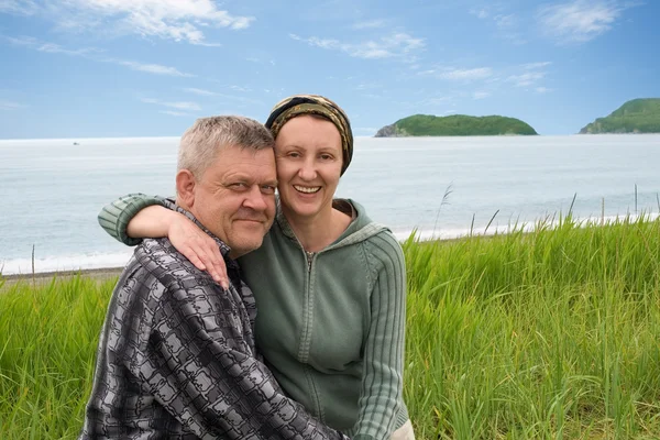 Happy middle aged couple by the sea.
