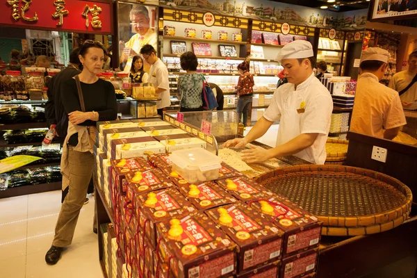 Confectioner manufactures biscuits in candy store in Macau