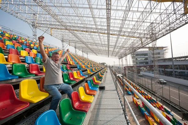 Screaming man with hands up in the seats for spectators