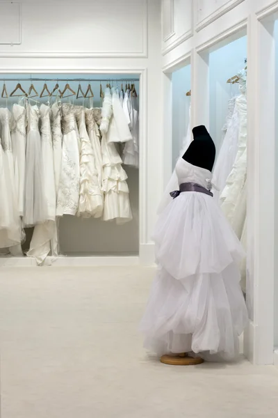 The range of wedding dresses on hangers and on a mannequin in th