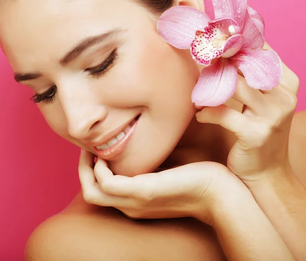 Happy woman with orchid flower