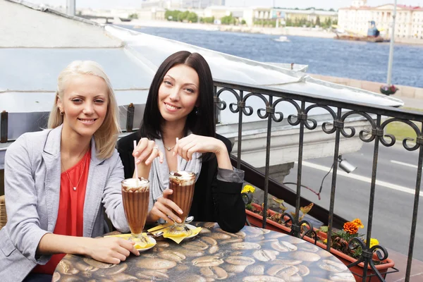 Smiling women drinking a coffee