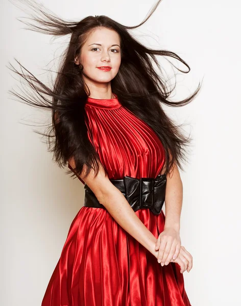 Woman in red dress with long dark hair