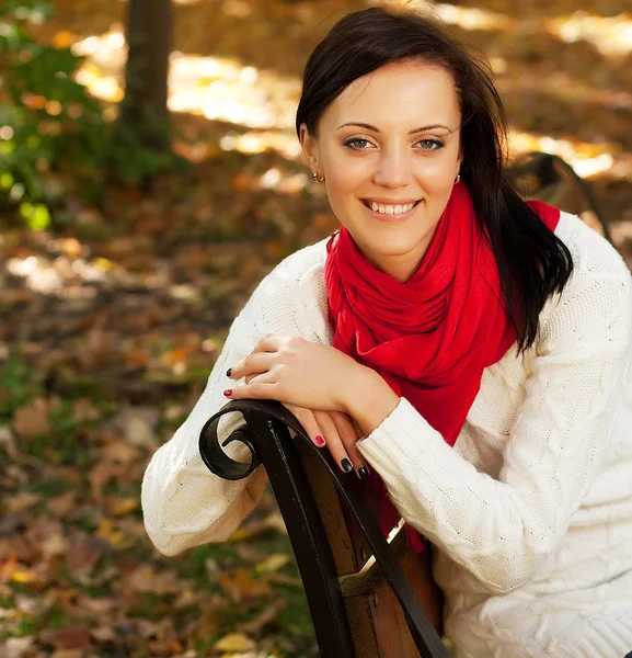 Girl on bench in autumn park