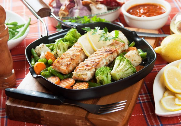 Grilled salmon steak and vegetables