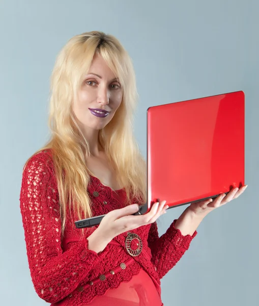 The young beautiful woman in red blouse with the red laptop