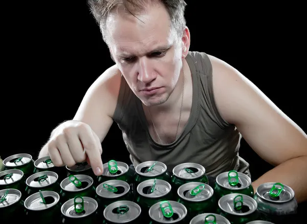 The drunk man and is a lot of empty beer can — Stock Photo #24738177