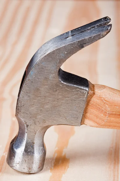 Hammer head on a wooden surface