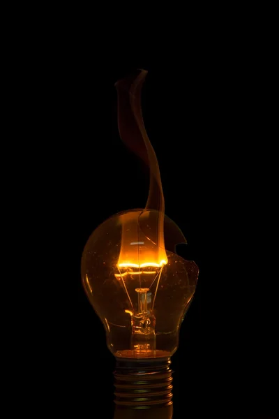 Broken light bulb burn out with flame