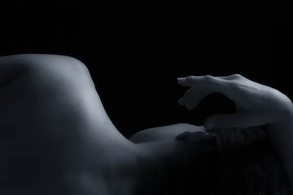 Body scape of woman back in low light emotion artistic conversio